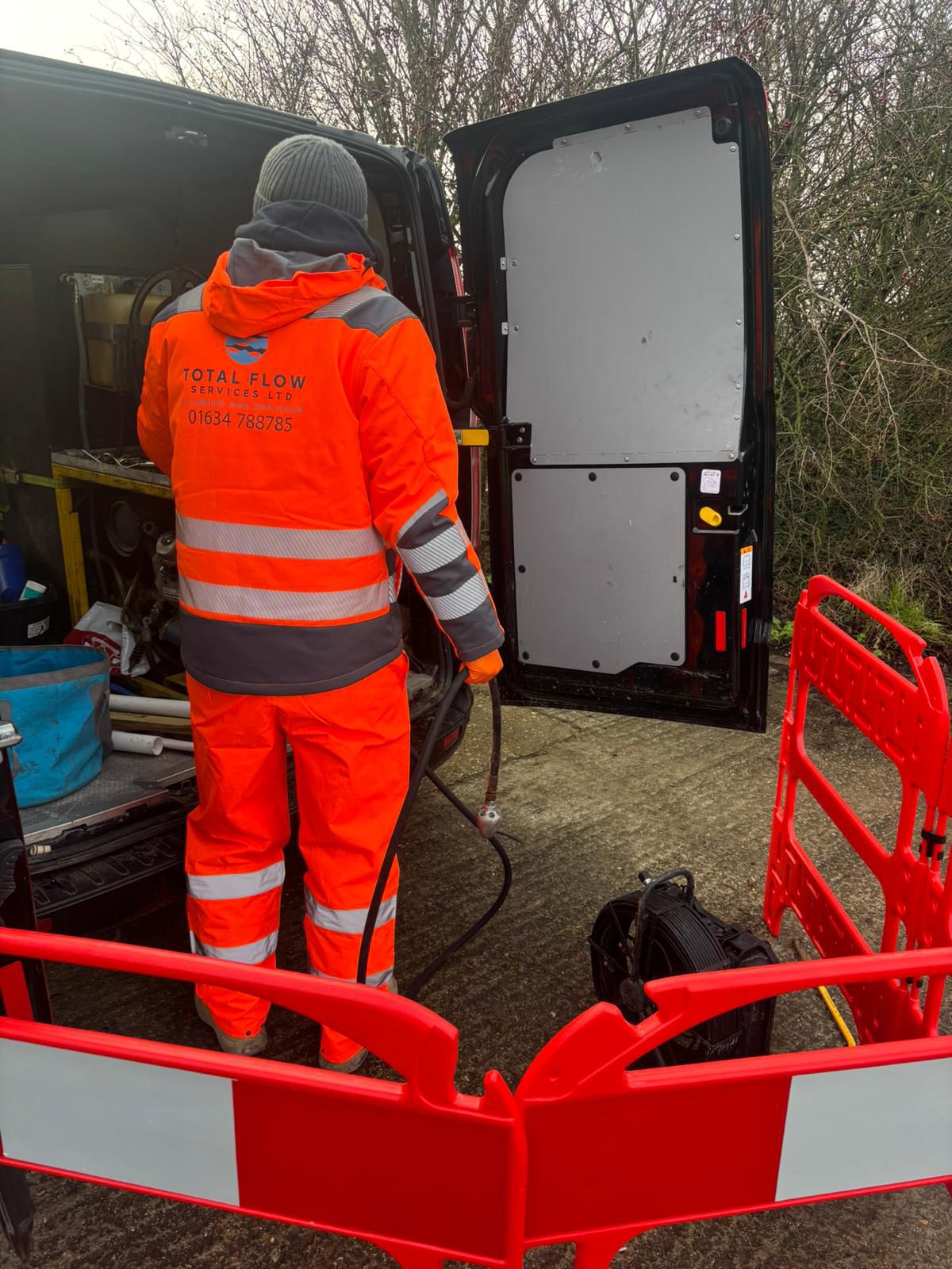High-pressure drain jetting equipment set up from a work van on a Kent driveway